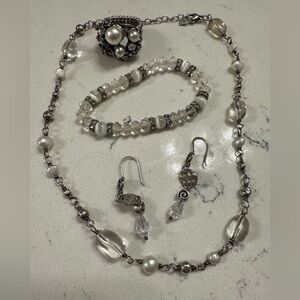 Jewelry set with necklace, bracelet, earrings and ring.